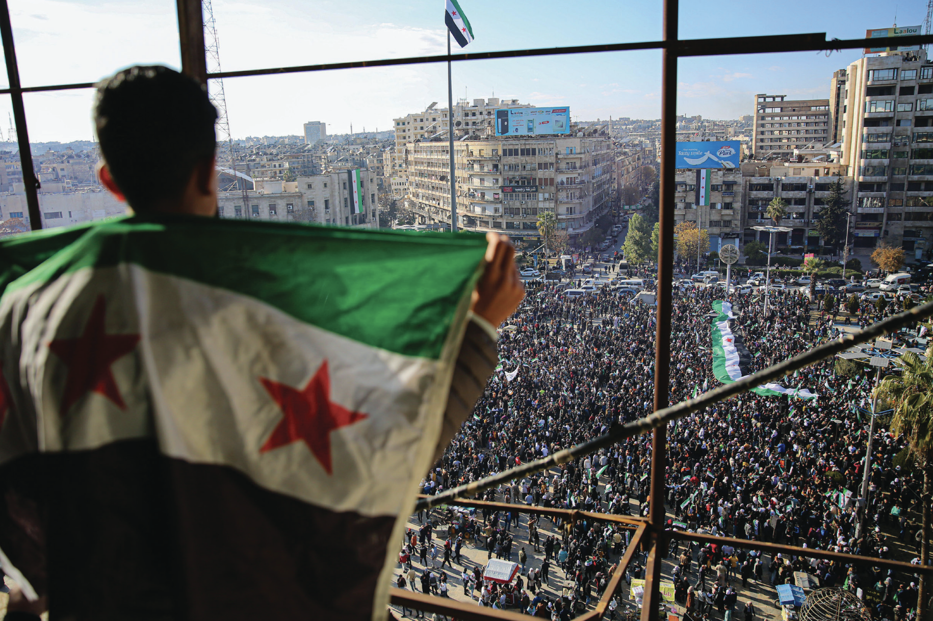 Large crowd converges into Saadallah al-Jabiri Square in Aleppo, Syria, on December 13, 2024, to mark overthrow of Syrian regime of Basharal-Asad by opposition forces headed by Hayat Tahrir al-Sham (Images Live/Alamy)
